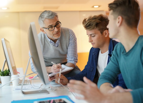 Teacher with students in computing class