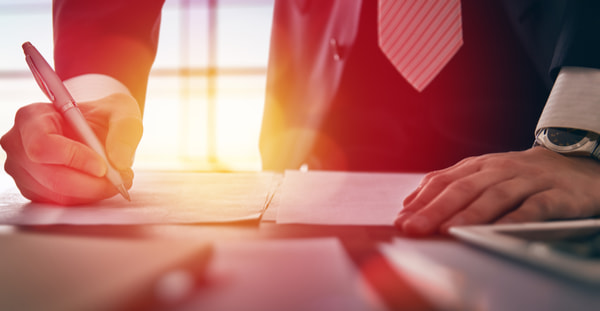 Close up businessman signing documents