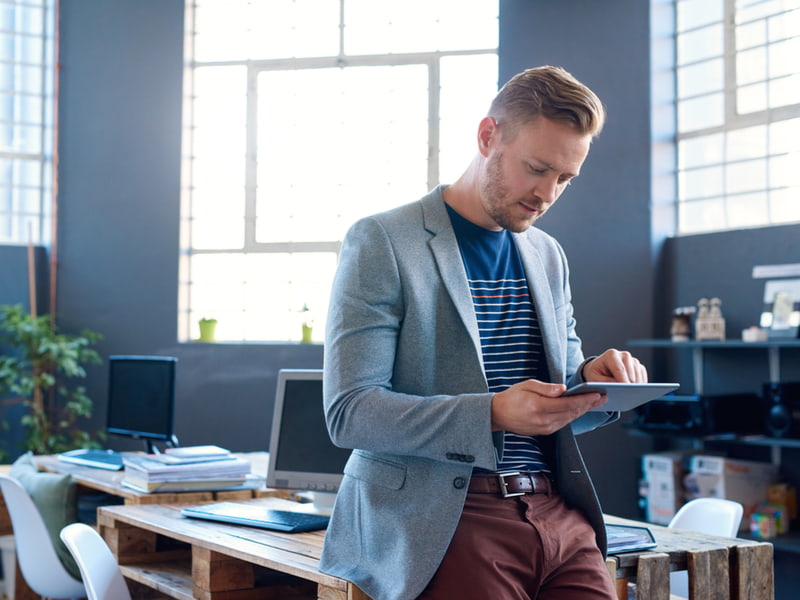Businessman using his tablet at work