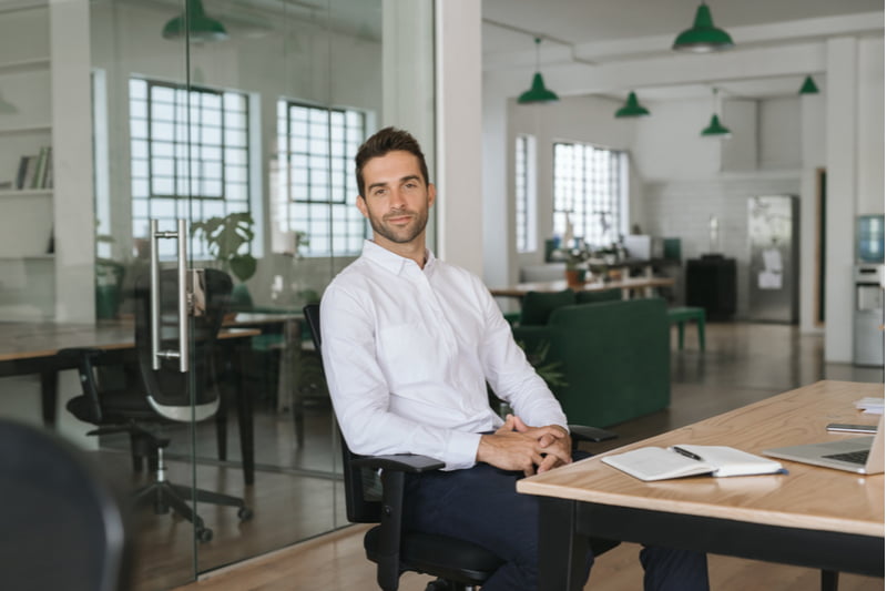 Confident young businessman sitting in a chair