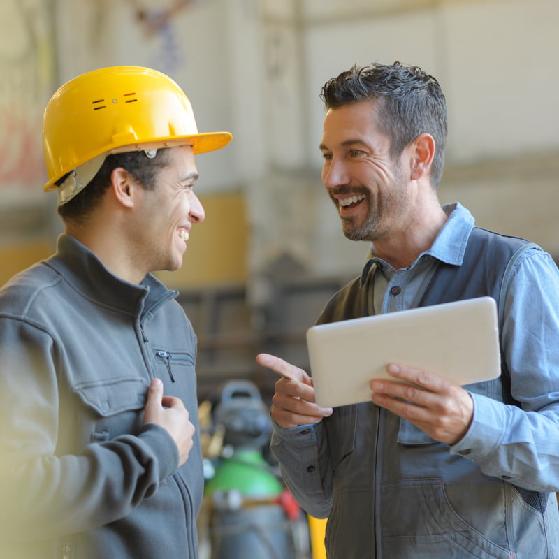 Workers talking and laughing at a factory