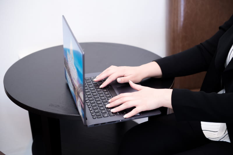 Hand of a woman typing on laptop